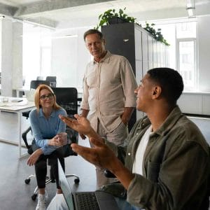 Three staff in a team in dialogue